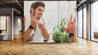 cheerful beaded guy caring of his skin Wall mural