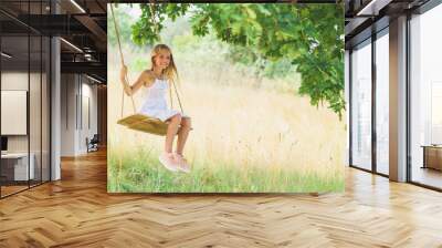 Cheerful kid playing on meadow Wall mural