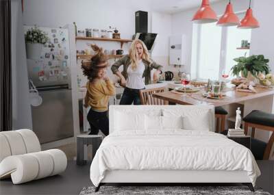 Cheerful mother and daughter having fun at home Wall mural