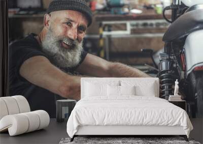 Cheerful smiling elder man in workshop Wall mural