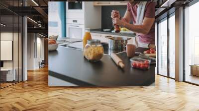 Cook preparing an Italian dinner at his kitchen Wall mural