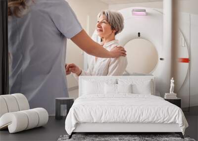 Cropped view of the female doctor calming senior patient woman before the MRI scanning Wall mural