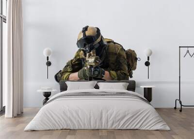 Defender watching at special weapon while lying on ground. Military concept Wall mural