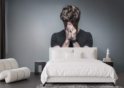 Depressed young man suffering from headache Wall mural