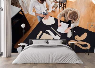 Designers making patterns on the black fabric Wall mural