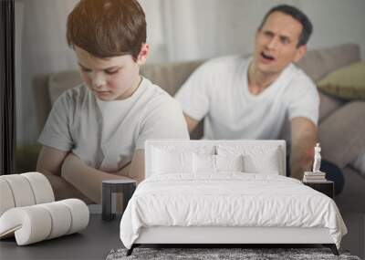 Do not be so naughty. Annoyed man is screaming at his upset son. Focus on depressed boy Wall mural