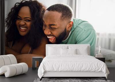 Funny couple laughing in bed stock photo Wall mural