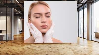 General practitioner analyzing human facial skin Wall mural