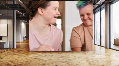 Girl with down syndrome laughing out loud and looking away while enjoying Wall mural