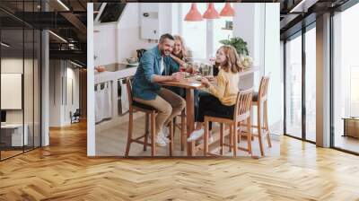 Happy family spending time together and enjoying dinner at home Wall mural