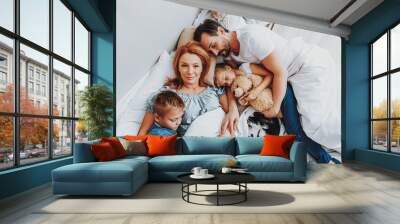 Happy loving family sleeping together in bed Wall mural