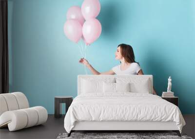 Happy young woman having fun with inflatables Wall mural