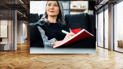 Inspired businesswoman looking away with smile stock photo Wall mural