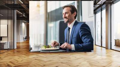 Joyful man having lunch in cafe Wall mural