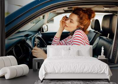 Lady doing make-up and ringing while driving stock photo Wall mural