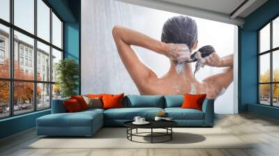 Lady washing hair while relaxing under stream of water. She gesticulating hands Wall mural