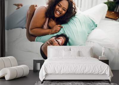 Laughing couple on the white bed stock photo Wall mural