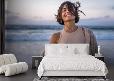 Laughing woman smiling toothy while enjoying of the windy summer evening Wall mural