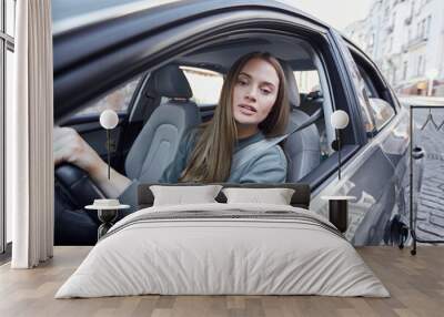 Lovely young female driver watching the road Wall mural