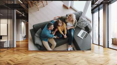 Loving happy parents spending time with their daughter Wall mural