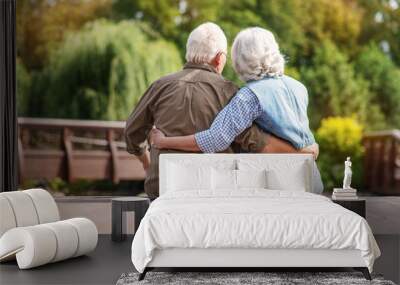 Loving mature couple resting near lake Wall mural