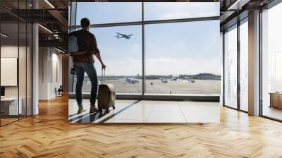 Male tourist looking at flight Wall mural