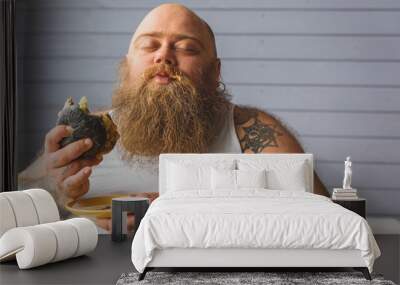 Man eating a hamburger Wall mural