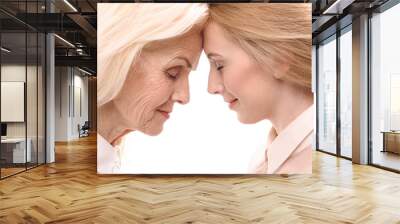 old lady inclining forehead to younger woman Wall mural