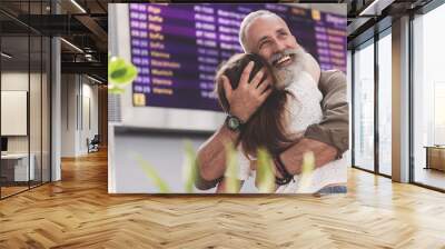 Outgoing old man hugging girl on meeting Wall mural