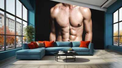 Portrait of fearless young man with attractive body hiding hands Wall mural