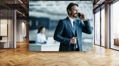 Portrait of outgoing boss talking on mobile during job. Glad professional communication concept Wall mural