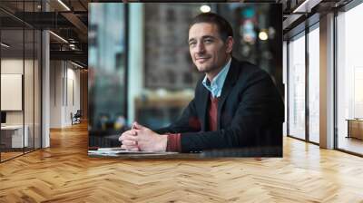 Portrait of smiling man situating at desk in confectionary shop. Relax concept Wall mural