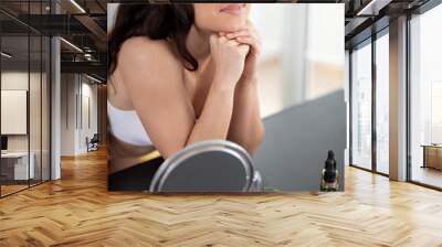 Pretty lady leaning on table with beauty tools and accessories Wall mural