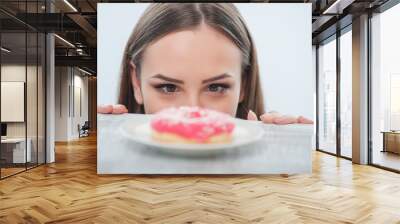 Pretty young woman wants to eat sweet food Wall mural