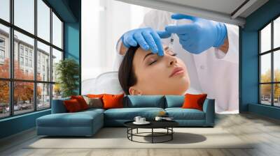 Serene woman receiving injection in face Wall mural