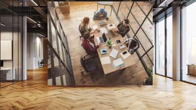 top view happy women and satisfied male talking while having job with gadgets in office. friendly st Wall mural