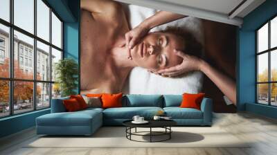 Top view of anti-age massage of face to lady Wall mural