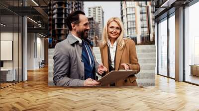 Woman standing next to a male broker Wall mural