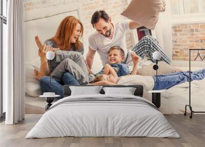 Young family being playful at home Wall mural