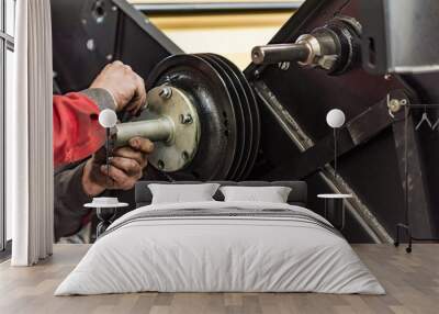 Industrial worker assembles agricultural equipment at plant Wall mural