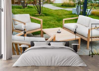 Outdoor patio with wooden armchairs and table Wall mural