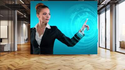 Young business lady works with virtual graphic interface in futuristic office Wall mural