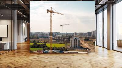 Construction crane working on large construction site Wall mural