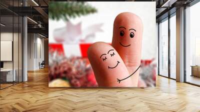 Faces of fingers hugging each other isolated on Christmas decorated background. Happy family celebrating Christmas day concept Wall mural