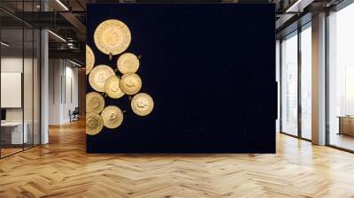 The pile of full, half and quarter Turkish gold coins on a dark navy blue background Wall mural