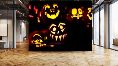 Carved Jack-o-lanterns lit at night for Halloween	 Wall mural