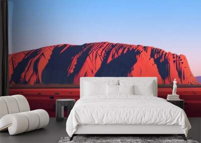 A desert landscape with a large red rock formation in the background Wall mural