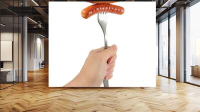 Hand holding fork with two fried sausages isolated on white background          Wall mural