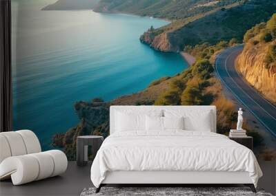 Mountain road near blue sea in summer. Top view of road, trees, azure water, mountain. Beautiful landscape with highway, rocks, sea coast. Mountain road by the sea, aerial view. Travel concept. Wall mural