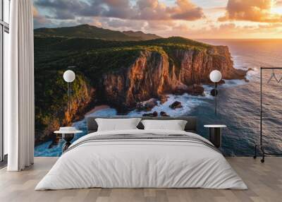 Sunset over the dramatic cliffs of La Pointe des Châteaux in Guadeloupe, with vibrant waves and lush vegetation Wall mural